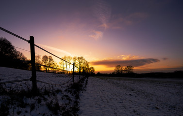 Sunset behind snowy Field