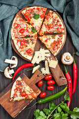 Freshly prepared pizza, baked with herbs and vegetables