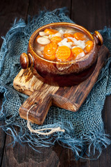 Bowl of delicious vegetables soup on wooden table