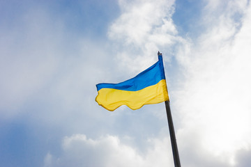 Ukrainian blue yellow flag at sunlight background. flag of european country.
