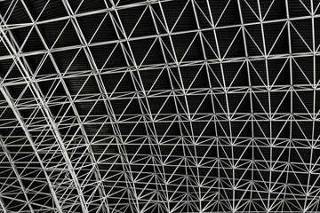 Abstract view of a ceiling of a big roof from below with repeating steel structure. Abu Dhabi