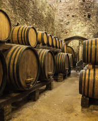 Oak barrels with the wine at the cellar