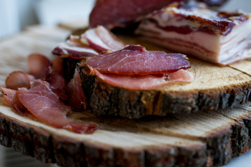  prosciuto slices  on wooden chopping board
