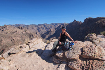 Woman enjoying expansive views at the end of the Blackett's Ridge Trail in the Santa Catalina Mountains near Tucson, Arizona.