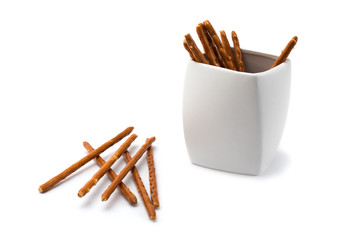 Bread sticks in white bowl isolated on white background.