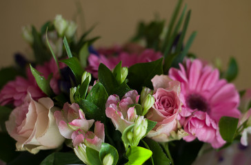 bouquet of flowers from pink gerberas, irises, lilies, roses; on a bouquet of flowers water drops (horizontally, close up )