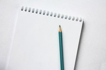 blank Notepad on a white background and a pencil