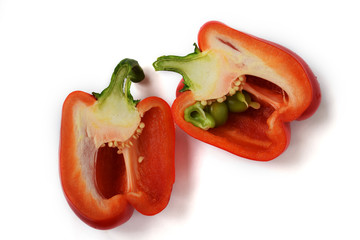 Red sweet pepper cut in half inside longitudinal section isolated on white background