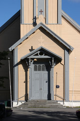 Facade detail with portal and pediment of the wooden Domkirke Church in Tromso, Norway