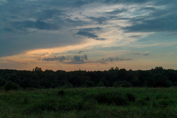 sunset over green field