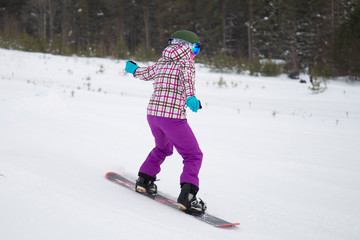 snowboarder jumping on mountain slope