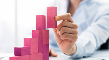 Businesswoman building a growing financial chart