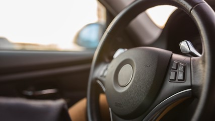 interior, steering wheel of a modern business car in the evening. backlight panel.