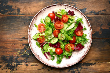 Vegetable salad with tomato and cucumber.Top view with copy space.