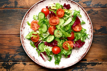 Vegetable salad with tomato and cucumber.Top view with copy space.