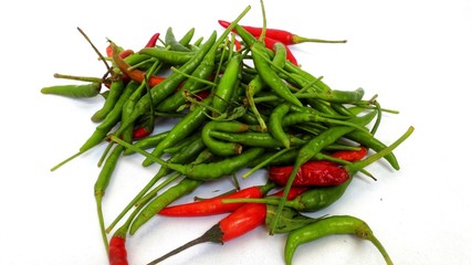 Paprika, green and red on a white background.