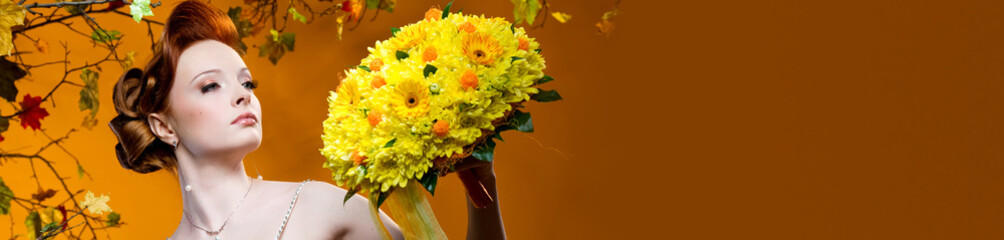 Beautiful redhead bride with a bouquet of flowers