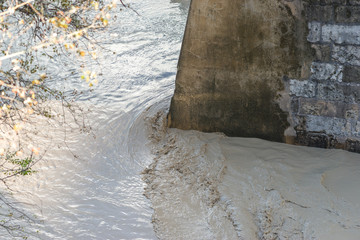 Detail of the water crashing against a stone bridge in a flood - 251082242