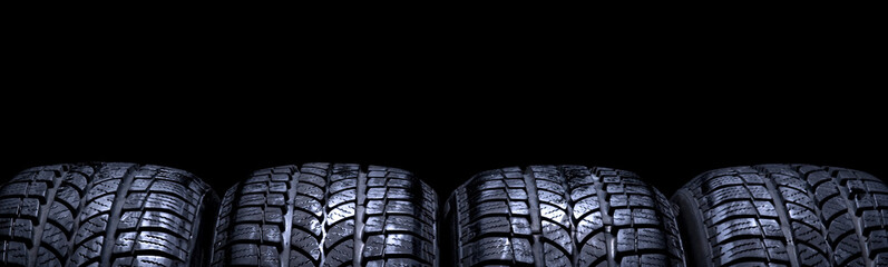 Car tires isolated panorama on black background