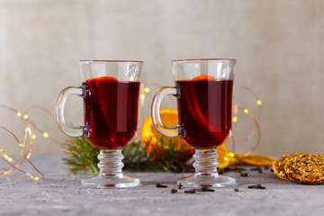 mulled red wine with spices and orange on dark background. warming drink