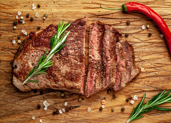 Ready to eat New York black angus steak with ingredients on a cutting board. Ready meal for dinner...