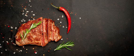 Ready-to-eat steak of New York black angus beef breeds with ingredients on a concrete background....