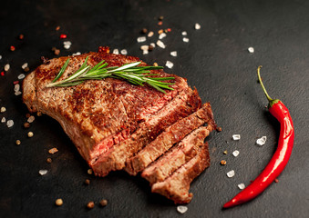 Ready-to-eat steak of New York black angus beef breeds with ingredients on a concrete background....