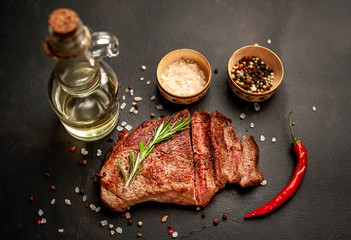 Ready-to-eat steak of New York black angus beef breeds with ingredients on a concrete background....