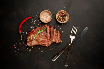 Ready-to-eat steak of New York black angus beef breeds with ingredients on a concrete background....