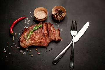 Ready-to-eat steak of New York black angus beef breeds with ingredients on a concrete background....