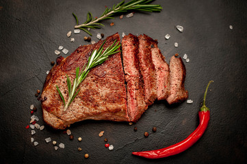Ready-to-eat steak of New York black angus beef breeds with ingredients on a concrete background....