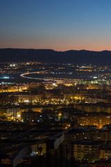 Obraz premium Afterglow with Cityscape and Mountains at Mirador del Barranco del Abogado Lookout in Granada, Spain