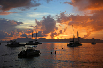 Fototapeta premium Boats silhouetted by the sunset in the British Virgin Islands