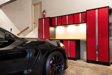 Home garage interior highly organized and clean with parked car