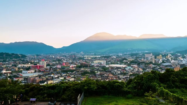 Beppu, Japan. A sunset time-lapse in a resort town of Beppu, Japan, with a view of mountains embracing the city and layers of sun
