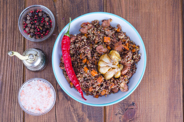Red rice, risotto, pilaf with chicken and vegetables, garlic
