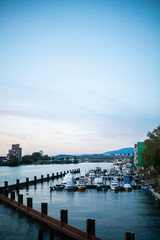 Obraz premium Quiet Small Boat Harbor on River Landscape Blue Sky Afternoon Peaceful Environment