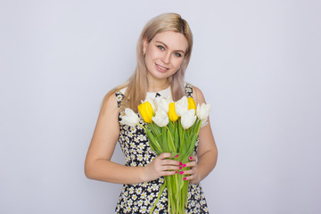 Blonde woman holding bouquet of tulips