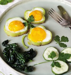 green breakfast on St. Patrick's Day. eggs in the form of clover. Fried Eggs Shamrock  in Green Pepper rings with Braised Spinach. parsley leaves like clover leaves.