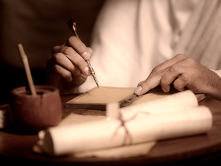 roman man writing on wax tablet with stylus