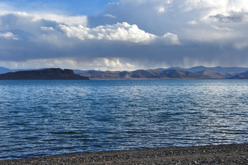 China. Great lakes of Tibet. Lake Teri Tashi Namtso in summer evening under a cloudy sky