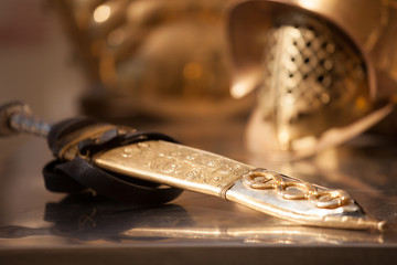 roman golden helmet and sword of ancient world