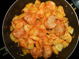 stewed potatoes with cutlets and vegetables