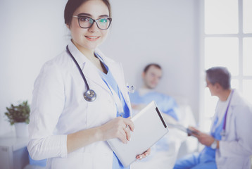 Female doctor using tablet computer in hospital lobby