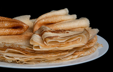 Pancakes, pancakes on a plate, dark background.
