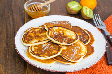 fried pancakes with sugar on plate to Shrovetide