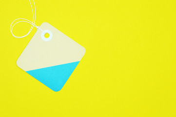 square paper tag on yellow background horizontal template