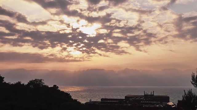 Timelapse of sun sey on cloudy at in Taiwan - organge sky with clouds passing