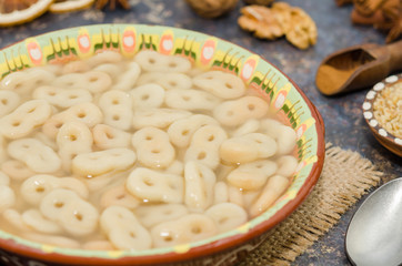 Romanian traditional food called mucenici. Eight shape made from flour, cooked and served with sugar, walnuts and cinnamon