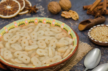Romanian traditional food called mucenici. Eight shape made from flour, cooked and served with sugar, walnuts and cinnamon